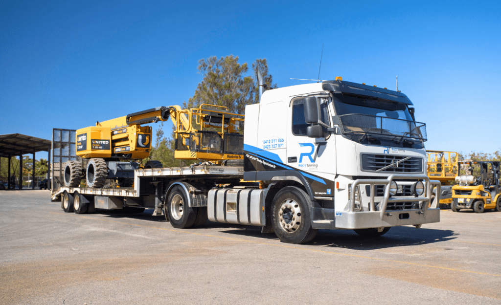 A Roc's Towing heavy haulage Volvo truck transporting a boom lift for United Equipment in Adelaide.