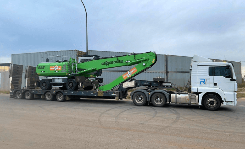 Roc's Towing heavy haulage truck transporting a Sennebogen material handler for Trading Metals