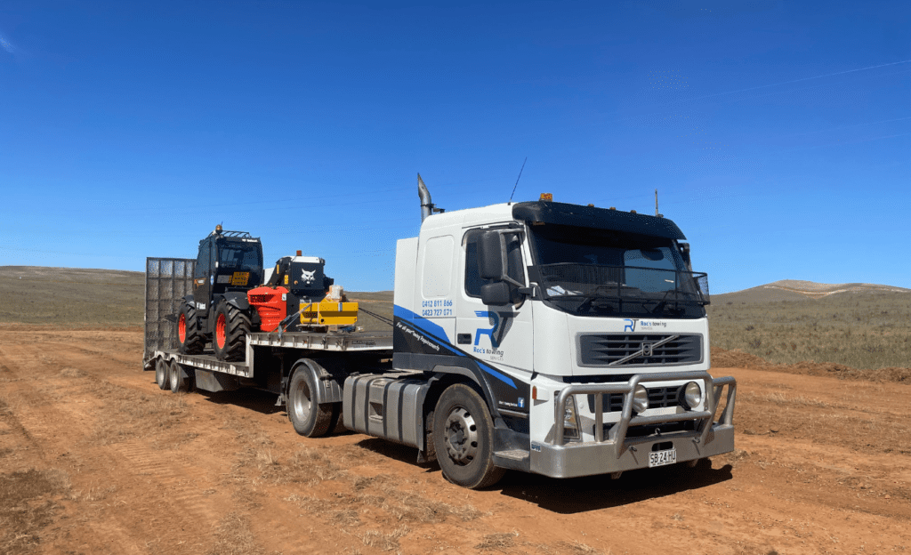 Roc's Towing heavy haulage Volvo FM 440 / Beavertail Trailer moving machinery out bush in Clare.
